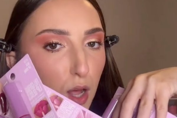 beauty influencer alexis simone holding up new lipsticks from dollar tree Dollar Tree Has 6 New Beauty Items for $1.25—Here's What a Makeup Expert Really Thinks About Them